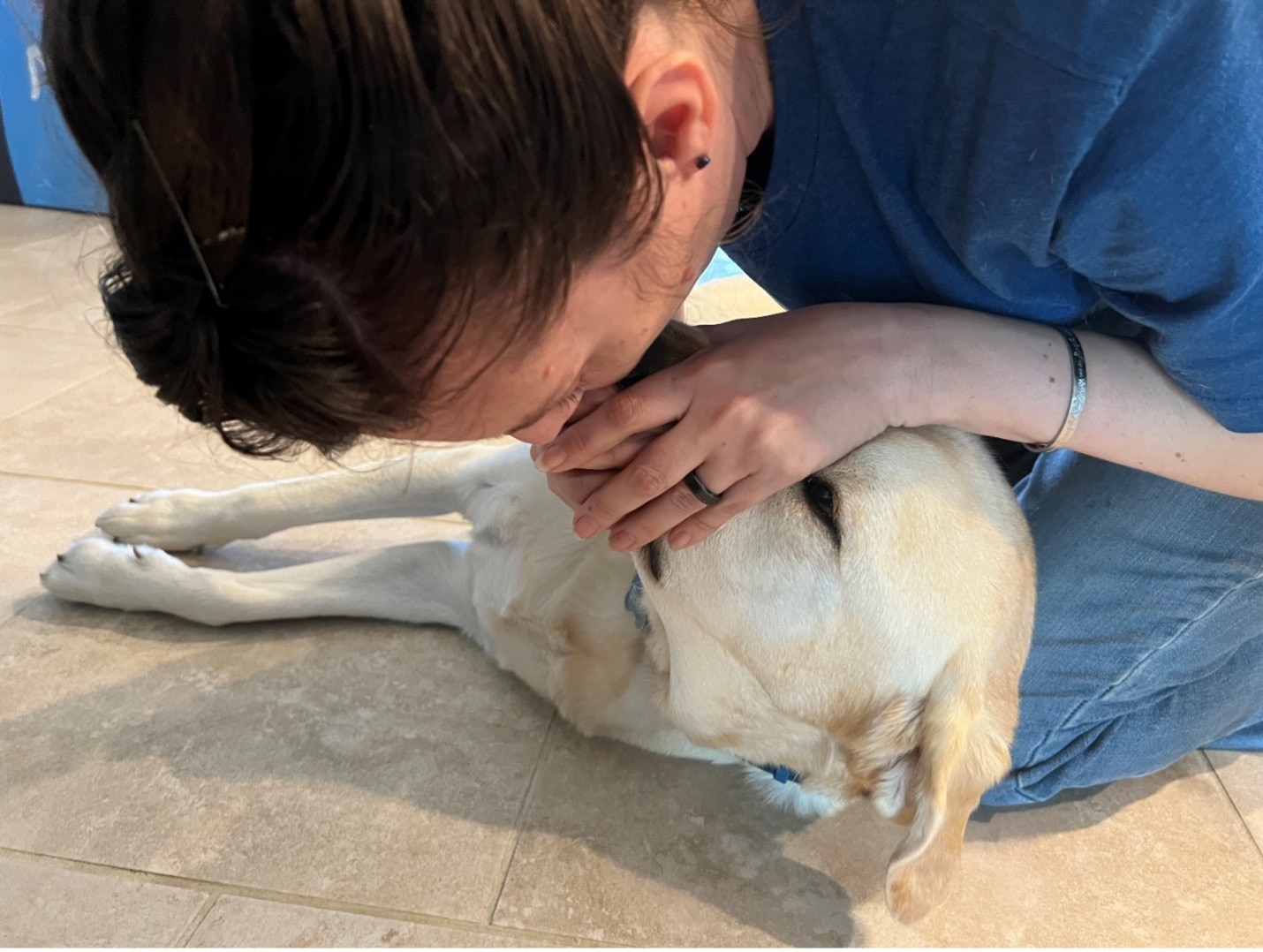 A veterinarian demonstrates blowing air into a dog’s muzzle during CPR.