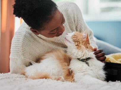 caring for adult cat-woman smiling at cat