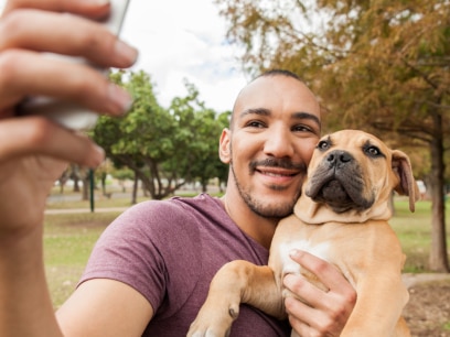 caring for new dog-man takes selfie of him and his dog