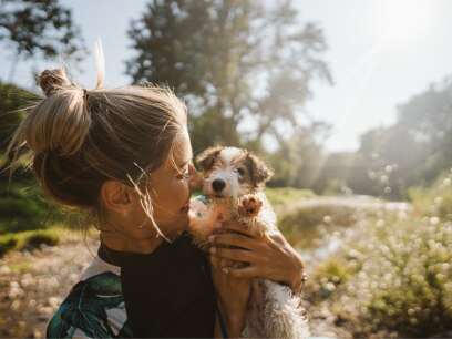 new puppy care-a woman holds up her new puppy