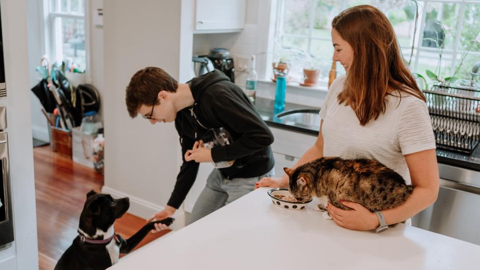 couple-in-kitchen-with-dog-and-cat