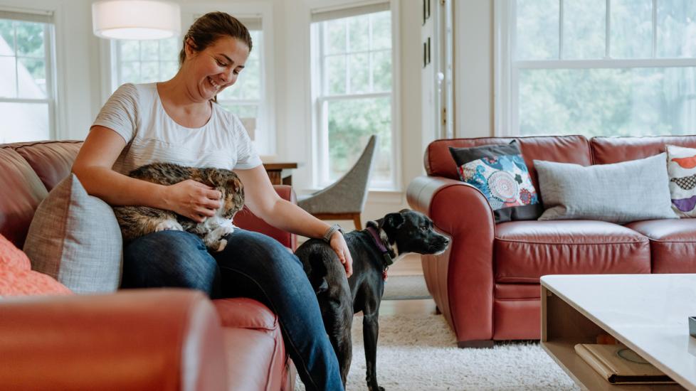woman-sitting-with-dog-and-cat
