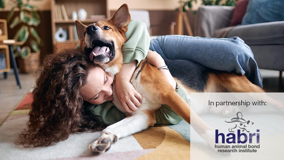 happy girl lying on floor with german shepherd dog playing and laughing with dog.