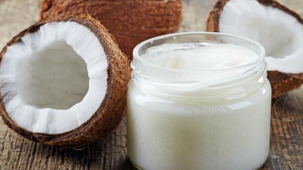 close up of opened coconuts and a glass of coconut milk